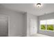 Bright bedroom features a double door closet, neutral walls, and window with outdoor views at 6320 Halcyon Garden Dr, Alpharetta, GA 30005