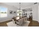 Bright dining room with a modern chandelier, hardwood floors, and an open view to the kitchen at 6320 Halcyon Garden Dr, Alpharetta, GA 30005