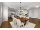 Open-concept dining room connecting to the kitchen and living areas, perfect for entertaining guests at 6320 Halcyon Garden Dr, Alpharetta, GA 30005