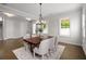 Elegant dining room with hardwood floors, a stylish chandelier, and ample natural light at 6320 Halcyon Garden Dr, Alpharetta, GA 30005