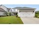 Charming two-story home with well-manicured lawn and attached two car garage at 6320 Halcyon Garden Dr, Alpharetta, GA 30005