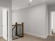 Upstairs hallway featuring neutral walls, interior doors, and a stair rail, providing a transition between rooms at 6320 Halcyon Garden Dr, Alpharetta, GA 30005
