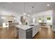 Bright, open kitchen with a large island, seamless access to living and dining areas, ideal for entertaining at 6320 Halcyon Garden Dr, Alpharetta, GA 30005