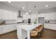 Modern kitchen featuring white cabinets, a large center island with seating, and stainless steel appliances at 6320 Halcyon Garden Dr, Alpharetta, GA 30005