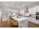 Gourmet kitchen with a large island, pendant lighting, and an open view to the dining area at 6320 Halcyon Garden Dr, Alpharetta, GA 30005
