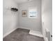 Clean, tiled laundry room features a wire shelf, utility sink, and window at 6320 Halcyon Garden Dr, Alpharetta, GA 30005