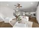 Spacious living room with hardwood floors, fireplace, open floor plan, seamlessly connecting to kitchen and dining areas at 6320 Halcyon Garden Dr, Alpharetta, GA 30005