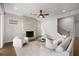 Inviting living room with fireplace, neutral decor, and plenty of natural light, great for relaxing and entertaining at 6320 Halcyon Garden Dr, Alpharetta, GA 30005