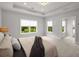 Bright main bedroom with plush carpet, neutral paint, and a view of the trees outside at 6320 Halcyon Garden Dr, Alpharetta, GA 30005