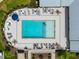 Overhead view of a luxurious community pool with ample lounge seating and a resident relaxing in the crystal-clear water at 6320 Halcyon Garden Dr, Alpharetta, GA 30005