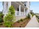 Inviting front porch with white columns, brick accents, and a well-maintained walkway at 6320 Halcyon Garden Dr, Alpharetta, GA 30005