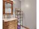 Bathroom featuring a vanity with mirror and a decorative shelving unit for storage and organization at 652 Post Oak Rd, Jonesboro, GA 30238