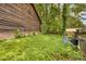 Property's side yard exhibits extensive ground cover, requiring attention for improved aesthetics and functionality at 652 Post Oak Rd, Jonesboro, GA 30238