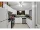 Well-lit kitchen with stainless steel appliances, white cabinetry, and attractive backsplash at 652 Post Oak Rd, Jonesboro, GA 30238