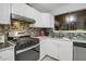 Functional kitchen featuring stainless steel appliances, ample counter space, and stylish backsplash at 652 Post Oak Rd, Jonesboro, GA 30238