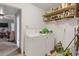 Functional laundry room featuring a washer, dryer, storage shelves, and ample space at 652 Post Oak Rd, Jonesboro, GA 30238