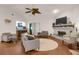 Bright living room with hardwood floors, neutral paint, fireplace, and comfortable seating at 652 Post Oak Rd, Jonesboro, GA 30238