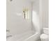 Modern bathroom features white tile, a showerhead, a soaking tub, and a window at 779-A Lynwood Se St, Atlanta, GA 30312