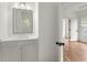 Bright powder room with white vanity and mirror, leading into an open bedroom with hardwood floors at 779-A Lynwood Se St, Atlanta, GA 30312