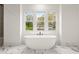 Bathroom with a freestanding tub, marble floors, and natural light at 779-A Lynwood Se St, Atlanta, GA 30312