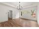 Bedroom with hardwood floors, tray ceiling, modern light fixture and three large windows at 779-A Lynwood Se St, Atlanta, GA 30312