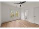 Bright bedroom with hardwood floors, a ceiling fan, and a view into an ensuite bathroom at 779-A Lynwood Se St, Atlanta, GA 30312