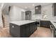 Spacious kitchen with a large island, stainless steel appliances, ample cabinet space, and stairs nearby at 779-A Lynwood Se St, Atlanta, GA 30312