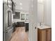 Modern kitchen with stainless steel appliances, hardwood floors, and a connected powder room at 779-A Lynwood Se St, Atlanta, GA 30312