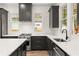 Beautiful kitchen with stainless steel appliances, modern range hood, white backsplash and countertops at 779-A Lynwood Se St, Atlanta, GA 30312