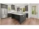 Modern kitchen featuring dark cabinets, a large island, stainless steel appliances, and hardwood floors at 779-A Lynwood Se St, Atlanta, GA 30312