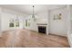 Living room with gas fireplace, hardwood floors, white walls, and many windows at 779-A Lynwood Se St, Atlanta, GA 30312