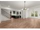Open concept kitchen and living room with hardwood floors and modern light fixtures at 779-A Lynwood Se St, Atlanta, GA 30312