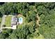 Aerial view of a beautiful home, backyard pool, and lush surrounding trees at 1642 Reflections Trl, Powder Springs, GA 30127
