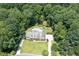 Aerial view of home with a large lawn, backyard pool, and lush surrounding trees at 1642 Reflections Trl, Powder Springs, GA 30127