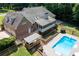 Aerial view of home's backyard, featuring a large pool, spacious deck, and outdoor space at 1642 Reflections Trl, Powder Springs, GA 30127