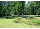 Spacious backyard features a wooded area and a small creek for added privacy and outdoor enjoyment at 1642 Reflections Trl, Powder Springs, GA 30127