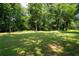 Expansive backyard features lush trees, a spacious lawn, and natural setting at 1642 Reflections Trl, Powder Springs, GA 30127