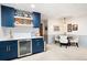 Finished basement features a wet bar with wine fridge and adjacent dining area, perfect for entertaining at 1642 Reflections Trl, Powder Springs, GA 30127