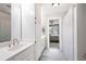 Bright bathroom featuring a sink and vanity with modern fixtures, a full mirror, and a separate shower behind a curtain at 1642 Reflections Trl, Powder Springs, GA 30127