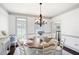 Charming dining room with a round table and traditional chandelier at 1642 Reflections Trl, Powder Springs, GA 30127