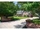 Manicured front yard and brick entrance leading to the charming brick home with a covered front porch at 1642 Reflections Trl, Powder Springs, GA 30127