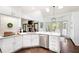 Well-lit kitchen featuring an island, white cabinetry, and stainless steel dishwasher at 1642 Reflections Trl, Powder Springs, GA 30127