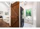 Convenient laundry room featuring a dark wood barn door and modern stacked washer and dryer at 1642 Reflections Trl, Powder Springs, GA 30127