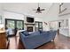 Open living room featuring a stone fireplace, hardwood floors, and glass doors to the screened porch at 1642 Reflections Trl, Powder Springs, GA 30127
