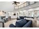 Spacious living room with hardwood floors, high ceilings, and a blue sectional sofa at 1642 Reflections Trl, Powder Springs, GA 30127