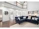 Bright living room featuring high ceilings, a second-story loft and a comfortable blue sofa at 1642 Reflections Trl, Powder Springs, GA 30127