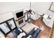 Bright open-concept living room with fireplace, hardwood floors, large sectional, and easy access to the kitchen and outdoor deck at 1642 Reflections Trl, Powder Springs, GA 30127