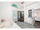 Luxurious main bathroom featuring a glass shower, soaking tub, and custom built-in shelving at 1642 Reflections Trl, Powder Springs, GA 30127