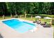 In-ground pool with tanning deck provides a refreshing and luxurious outdoor living experience at 1642 Reflections Trl, Powder Springs, GA 30127