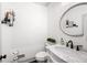 Stylish half bathroom with marble countertop, decorative mirror, and modern fixtures at 1642 Reflections Trl, Powder Springs, GA 30127